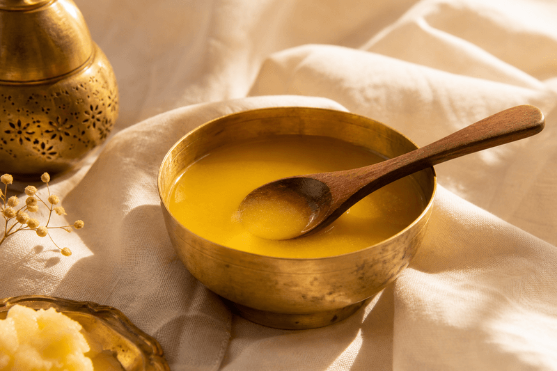 Golden ghee in a brass bowl